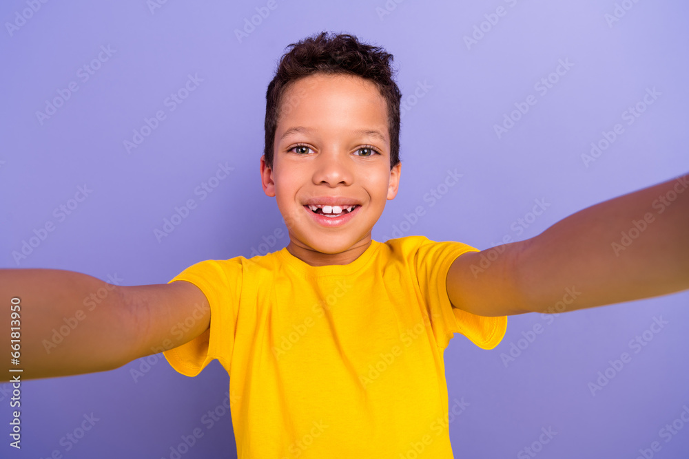 Wall mural photo of optimistic positive boy wear yellow trendy clothes shooting filming video isolated on purpl