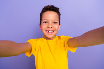 Photo of optimistic positive boy wear yellow trendy clothes shooting filming video isolated on purple color background