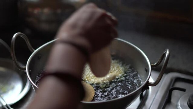 Fried Puri in a frying pan. very popular street food in India.famous indian food, Selective focus on subject