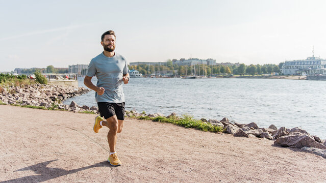 Athlete trainer exercises to warm up the body.  Mental and psychological health. Hobby jogging in running shoes. A healthy man who trains actively interval training.