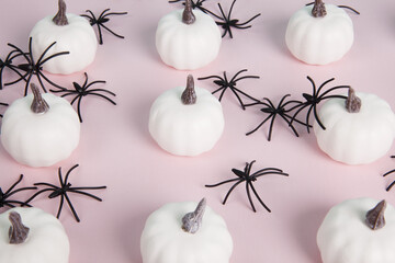  white mini pumpkins aligned symmetrically in the middle of a spider infestation