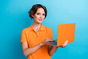 Photo of cheerful positive girl dressed orange polo communicating apple samsung modern device isolated blue color background