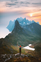 Norway travel outdoor activity traveler raised arms alone hiking in mountains summer vacations healthy lifestyle success motivation concept explore Senja island © EVERST