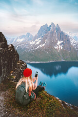 Woman blogger taking photo by smartphone of mountains and fjord landscape in Norway tourist girl traveling hiking with backpack  summer vacations healthy lifestyle outdoor - obrazy, fototapety, plakaty
