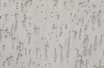 White plaster walls are ideal for background applications.Vertical textured background, textured putty, plaster. Rough lighted surface. Concrete wall with plaster. Gray concrete. concrete coat