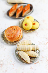Traditional Azerbaijan holiday Novruz background with green semeni,traditional azerbaijan sweets,shekerbura,qogal,paxlava,mutaki and different nuts and sweets,top view,space for copy