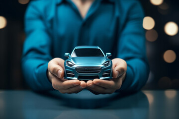 Small car model in hands. Purchase and insurance concept. Background with selective focus and copy space