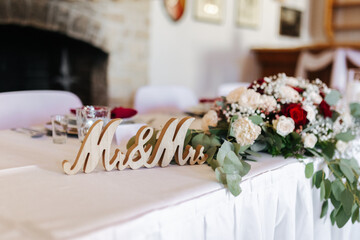 Wooden Mr and Mrs sign, decoration on the table at a wedding venue