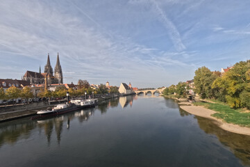 Fototapeta na wymiar Regensburg on the Danube with stone bridge in sunshine and clouds in autumn