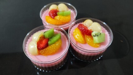Sweet dessert strawberry pudding with topping several fruits ready to eat