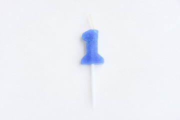 Blue candle number 1 on cement wall background, Birthday candle
