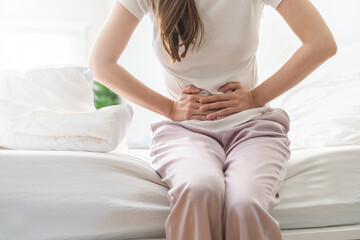 Flatulence ulcer, asian young woman, girl hands in belly, stomach pain from food poisoning, abdominal pain and digestive problem, gastritis or diarrhoea. Abdomen inflammation, menstrual period people.
