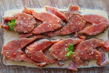 Red fish is cut into steaks and covered in creamy sauce.