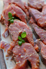Red fish is cut into steaks and covered in creamy sauce.