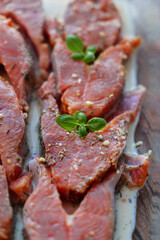 Red fish is cut into steaks and covered in creamy sauce.