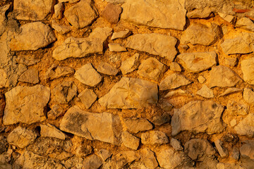 Detail shot of a plain limestone wall - stock photo