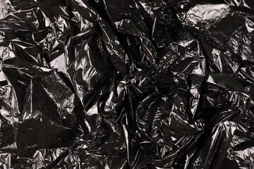 Texture of black plastic garbage disposable bag