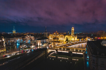 Oradea romania tourism aerial a cityscape at night with a stunning bridge and historic buildings