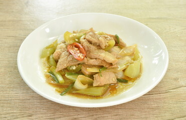 fried slice pork meat with onion and long chili on plate