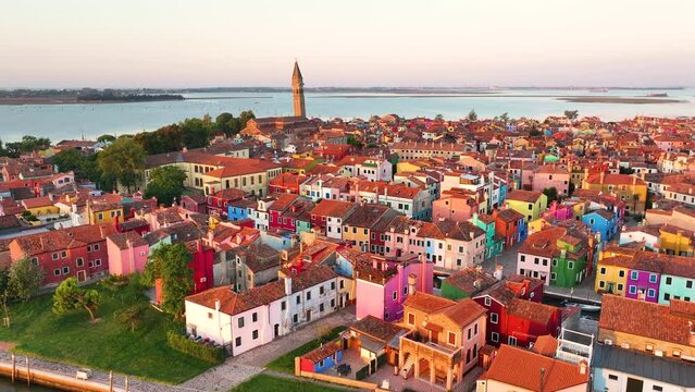 Sunrise splendor, aerial view of Burano colorful facades and iconic Campanile, Venice, Italy