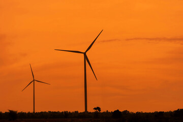 View of wind farm, with high wind turbines for generation electricity . Green energy concept.