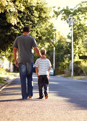 Back view, father and kid walking on street together for bonding, support and love on vacation or...