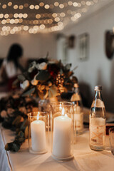 Beautiful lit candles as part of the table decoration at a wedding