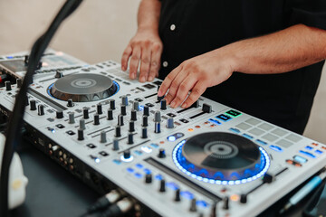 DJ's hands close-up working a turn table at a wedding party 