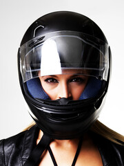 Motorbike helmet, portrait and sexy woman in studio isolated on white background. Biker, face and safety of serious girl, sports protection and fashion style, motorcyclist racer and beauty of driver