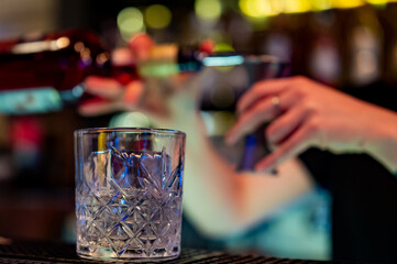 Ice cube in an empty glass on a bar counter in bar or pub