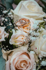Beautiful wedding rings and flowers close up, macro photo