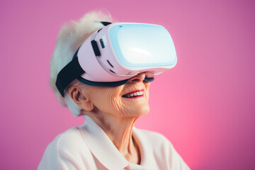Portrait of an elderly cheerful woman wearing virtual reality goggles on pastel pink background.