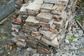 Solid clay brick used for construction, dark red brick. pile of bricks during the construction process.