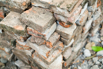 Solid clay brick used for construction, dark red brick. pile of bricks during the construction process.