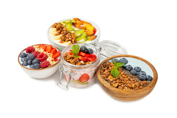 Bowl of granola with yogurt and fresh almonds, blueberries, raspberries,peach and strawberries isolated on white background. Healthy food. balanced breakfast.