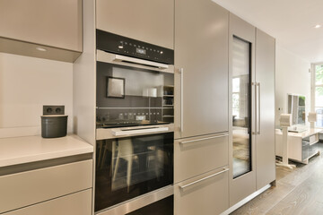 Fototapeta premium a modern kitchen with stainless steel appliances and an oven in the center of the photo is taken from the inside
