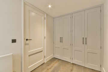 an empty room with white closets and wood floors in the room is very clean, but there is no one