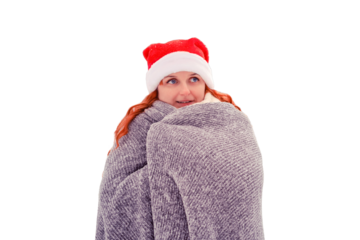 Woman in a Christmas hat wrapped herself in a gray plaid against a background of snow-covered fir trees in a winter park, isolated on a white background