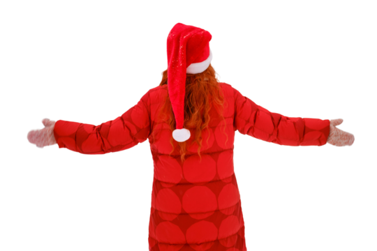 Woman stands with her back to the ground her arms outstretched among the winter, isolated on a white background. Red-haired woman on Christmas and New Year Eve walks in the winter in red clothes - Powered by Adobe
