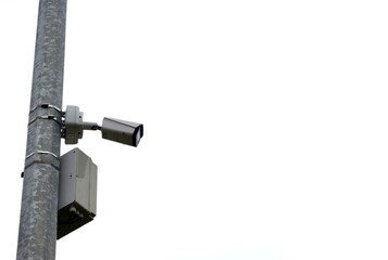 Surveillance camera on a pole isolated on a white background