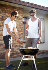 Men, grill and meat season for BBQ in the backyard with cooking and lunch with friends. Garden, food and chat outdoor with young people together ready for eating with barbecue lunch in a yard