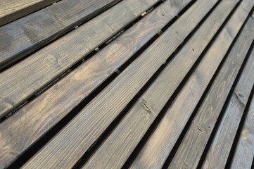 Wooden wall, fence made of brown diagonal boards with texture. Background.