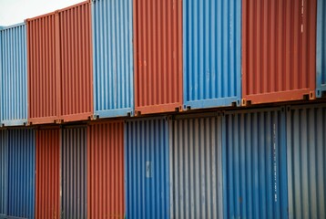row of different colored sea containers stacked