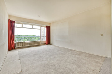 an empty living room with red drapes on the windows and carpeted floor in front of the window looking out
