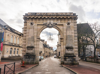 Fototapeta na wymiar Beaune, France - January 8 2023 - People passing the Porte Saint-Nicolas