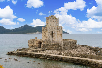 Fototapeta na wymiar Methoni, Greece - 8 February 2023 - Watch tower of the the Methoni Castle. An old mid sen.Venetian castle dating to the 1200s, on a rocky promontory with an arched bridge & an old prison.