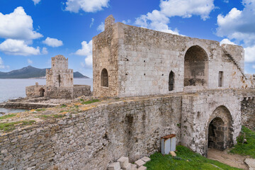Fototapeta na wymiar Methoni, Greece - 8 February 2023 - Watch tower of the the Methoni Castle. An old mid sen.Venetian castle dating to the 1200s, on a rocky promontory with an arched bridge & an old prison.
