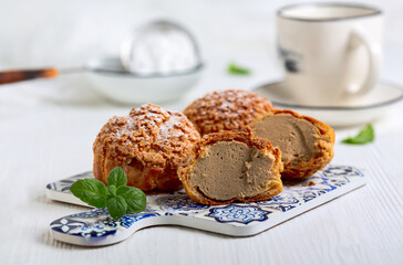Custard cakes (choux) with coffee cream.
