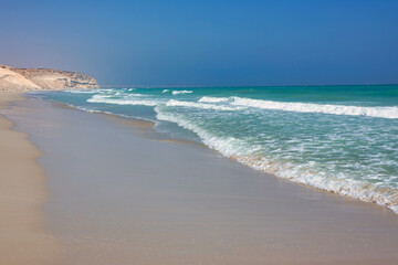 Turquoise Oman sea in the background mountains. Oman.