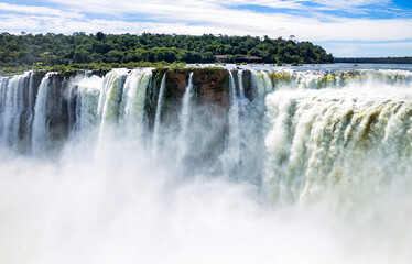 Devil's Throat of Iguazu (Iguacu) waterfall in Argentina, amazing sunshine falls landscape. Close up of view of majestic powerful water cascade, sunny day. World nature concept. Copy ad text space